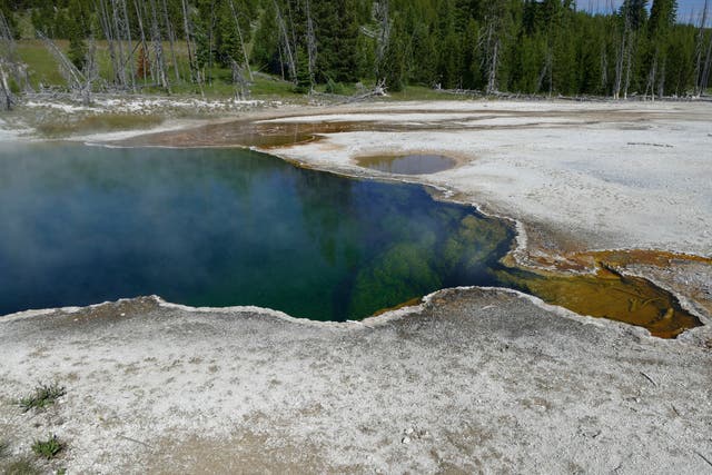 <p>FILE - In this photo provided by the National Park Service is the Abyss Pool hot spring in the southern part of Yellowstone National Park, Wyo., in June 2015. </p>