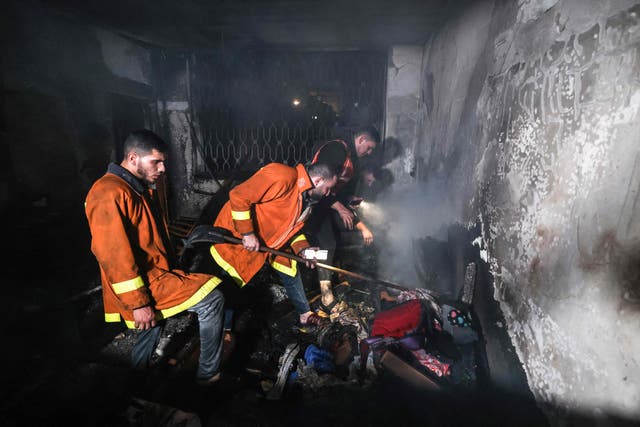<p>Palestinian firefighters extinguish a fire which broke out in one of the apartments in the Jabalia refugee camp in the northern Gaza strip</p>