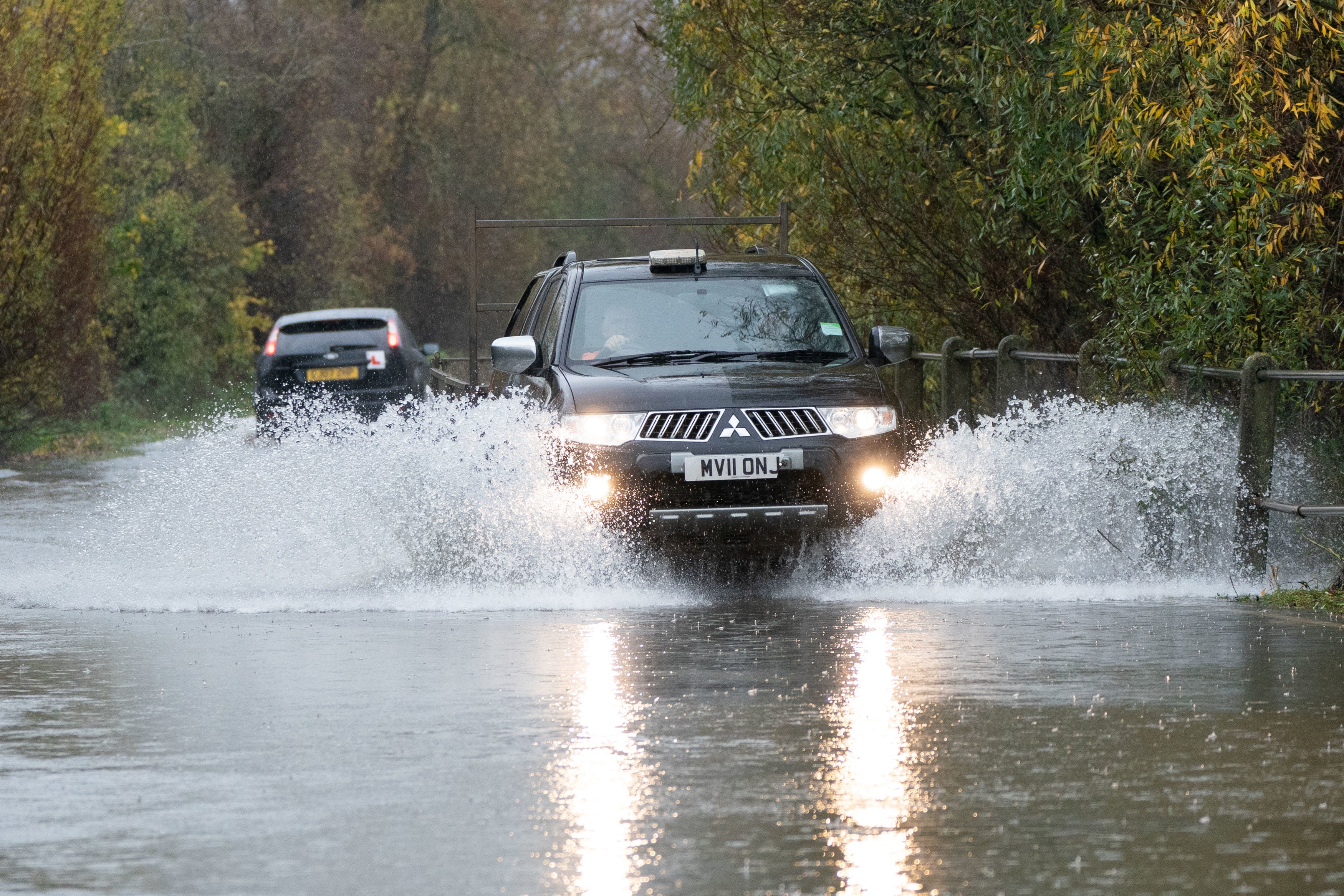 A motorist drives along a flooded road in Mountsorrel