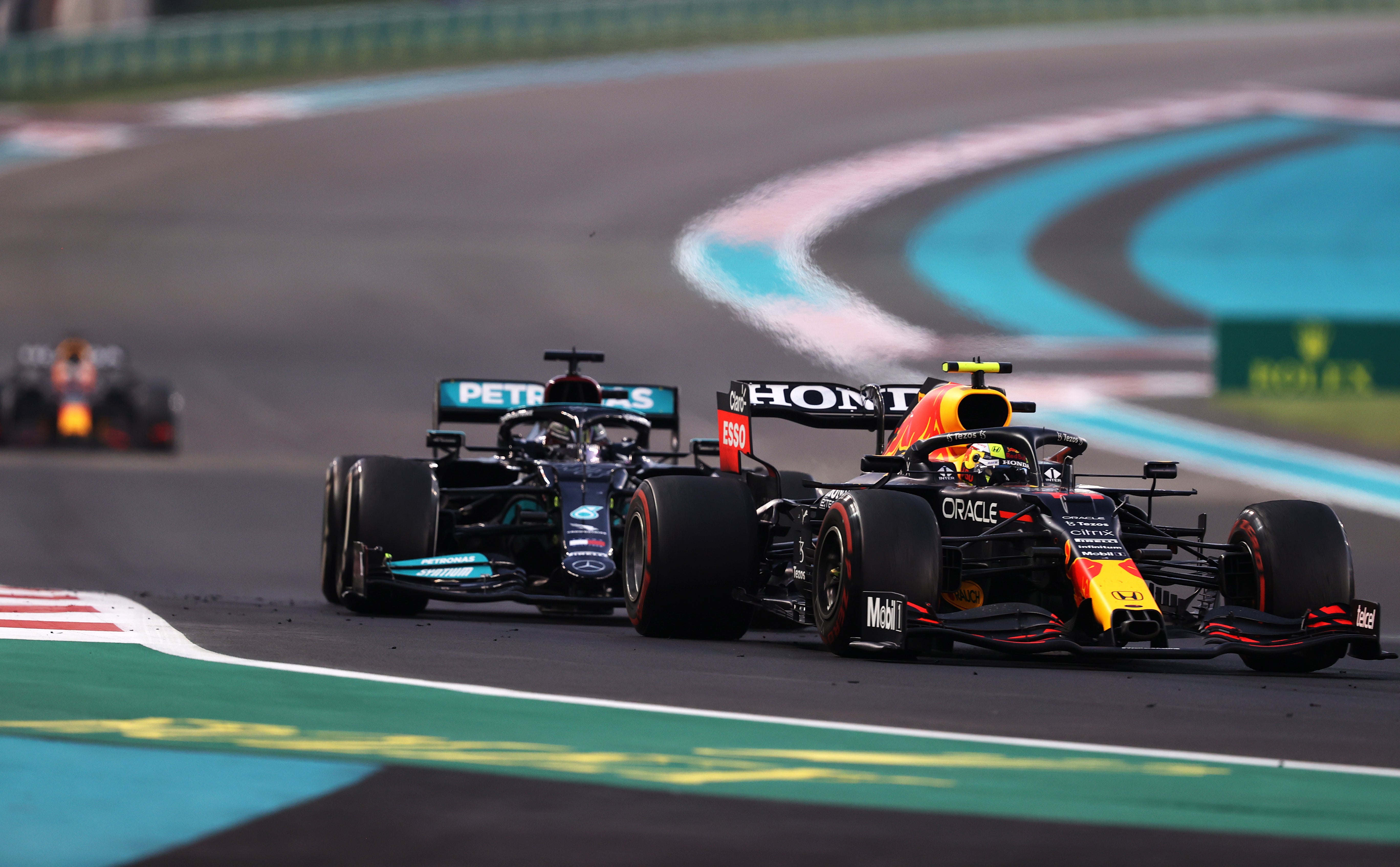 Sergio Perez defends against Hamilton – with Verstappen creeping up in the background