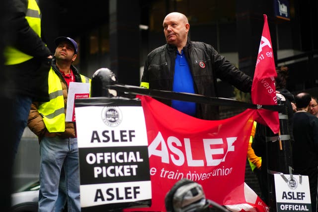 Members of the drivers union Aslef at 11 train operators will walk out on November 26 in a long-running dispute over pay (PA)