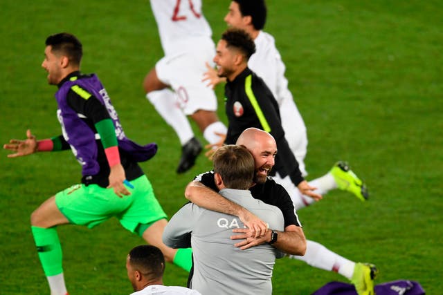 <p>Felix Sanchez (centre) embraces a member of his team during Qatar’s 2019 Asian Cup triumph</p>