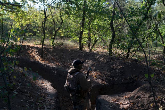 <p>A Ukrainian serviceman checks the trenches dug by Russian soldiers in a retaken area in Kherson region </p>