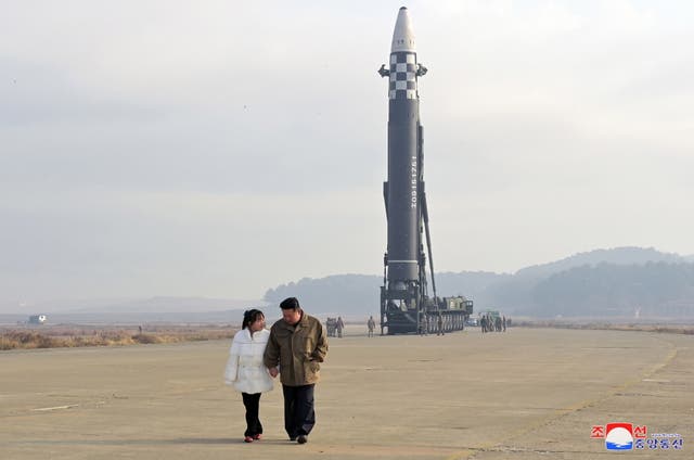 <p>North Korean leader Kim Jong-un, accompanied by his daughter during the test firing of a new type of intercontinental ballistic missile (ICBM) Hwasongpho-17 at Pyongyang International airport in Pyongyang</p>