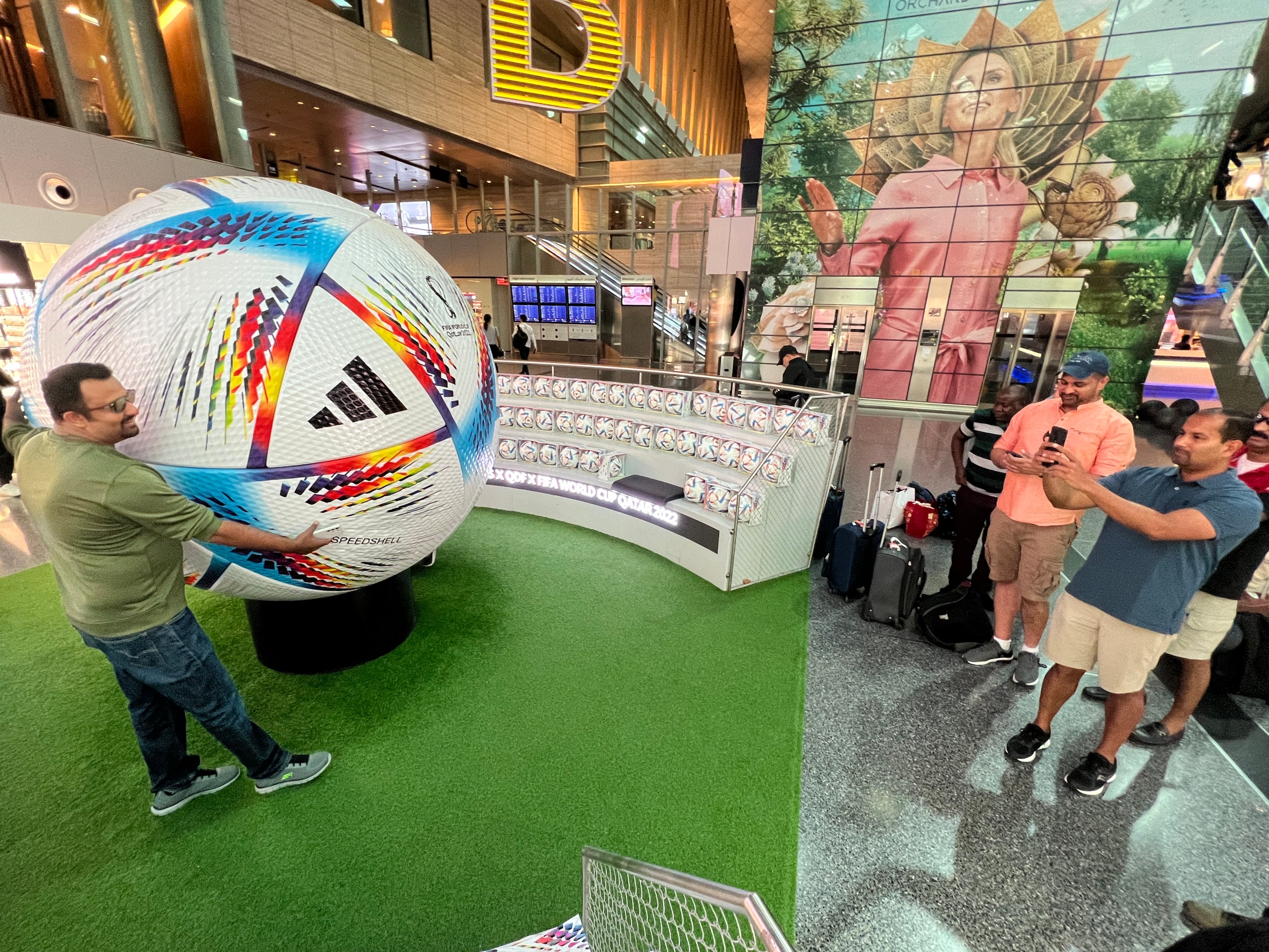 Global gathering: Fans with a giant football at Hamad International Airport in Doha