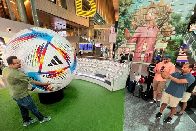 <p>Global gathering: Fans with a giant football at Hamad International Airport in Doha</p>