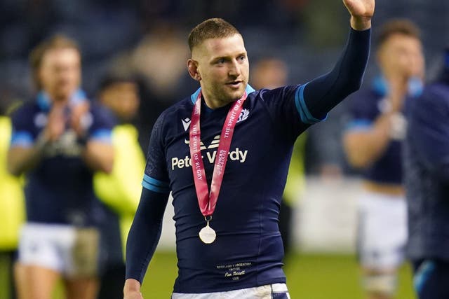 Star man Finn Russell salutes the Scotland fans at full-time (Jane Barlow/PA)
