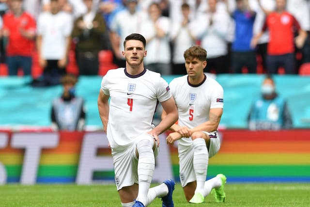 <p>Declan Rice and John Stones take the knee while representing England </p>