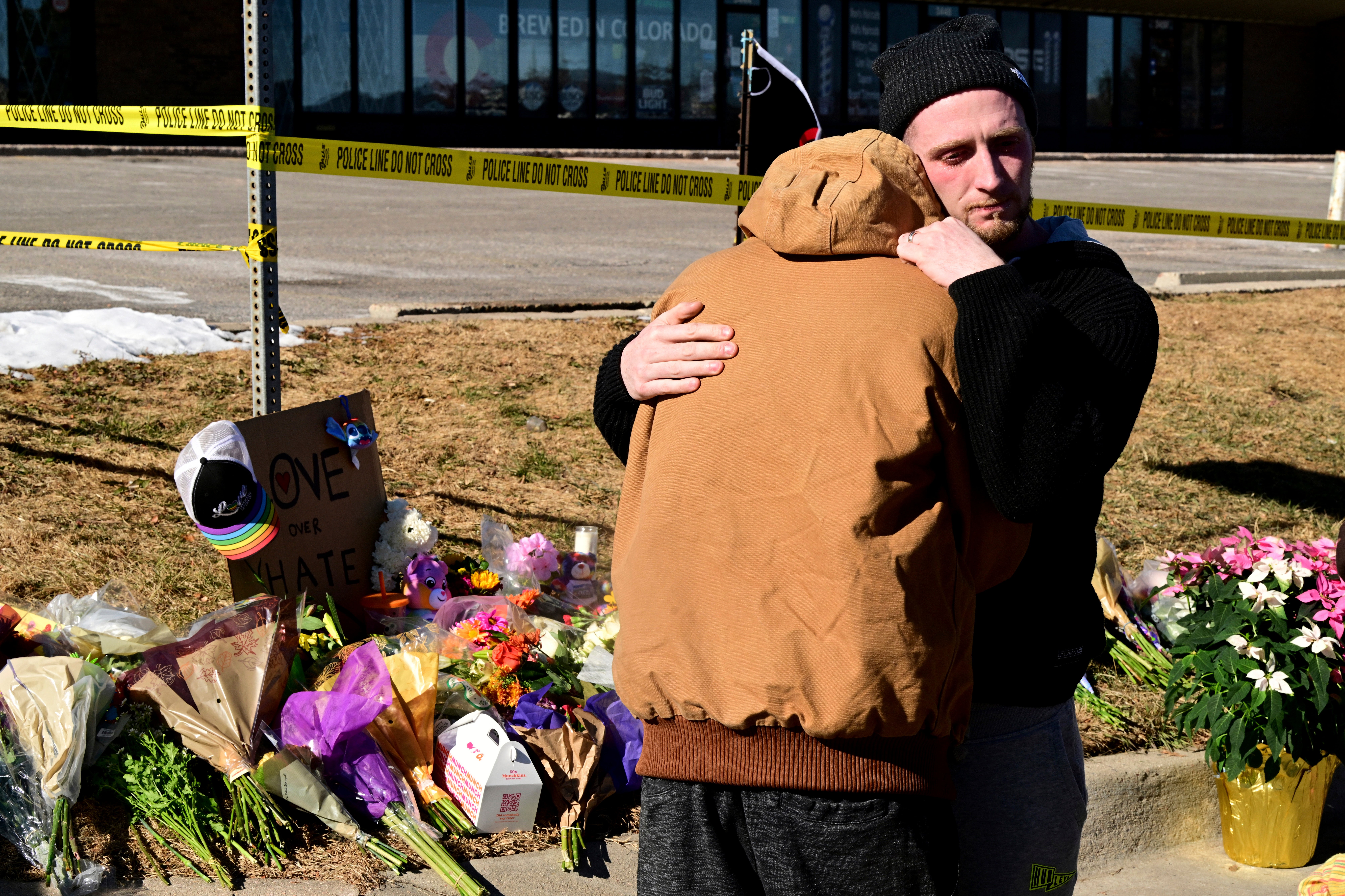 Tyler Johnston, right, comforts his friend Joshua Thurman at a memorial