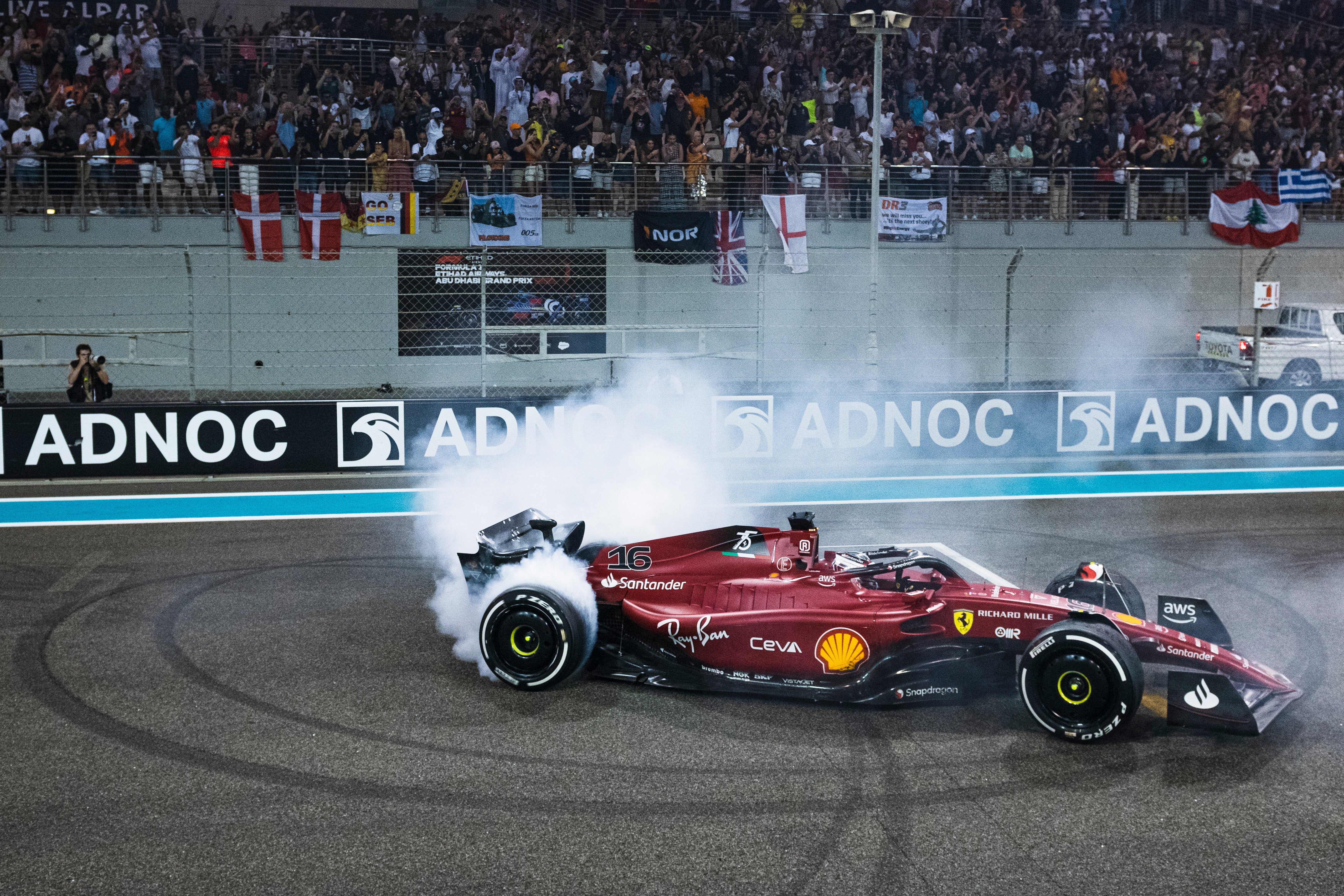 Charles Leclerc performs a celebratory donut in parc ferme at Yas Marina Circuit