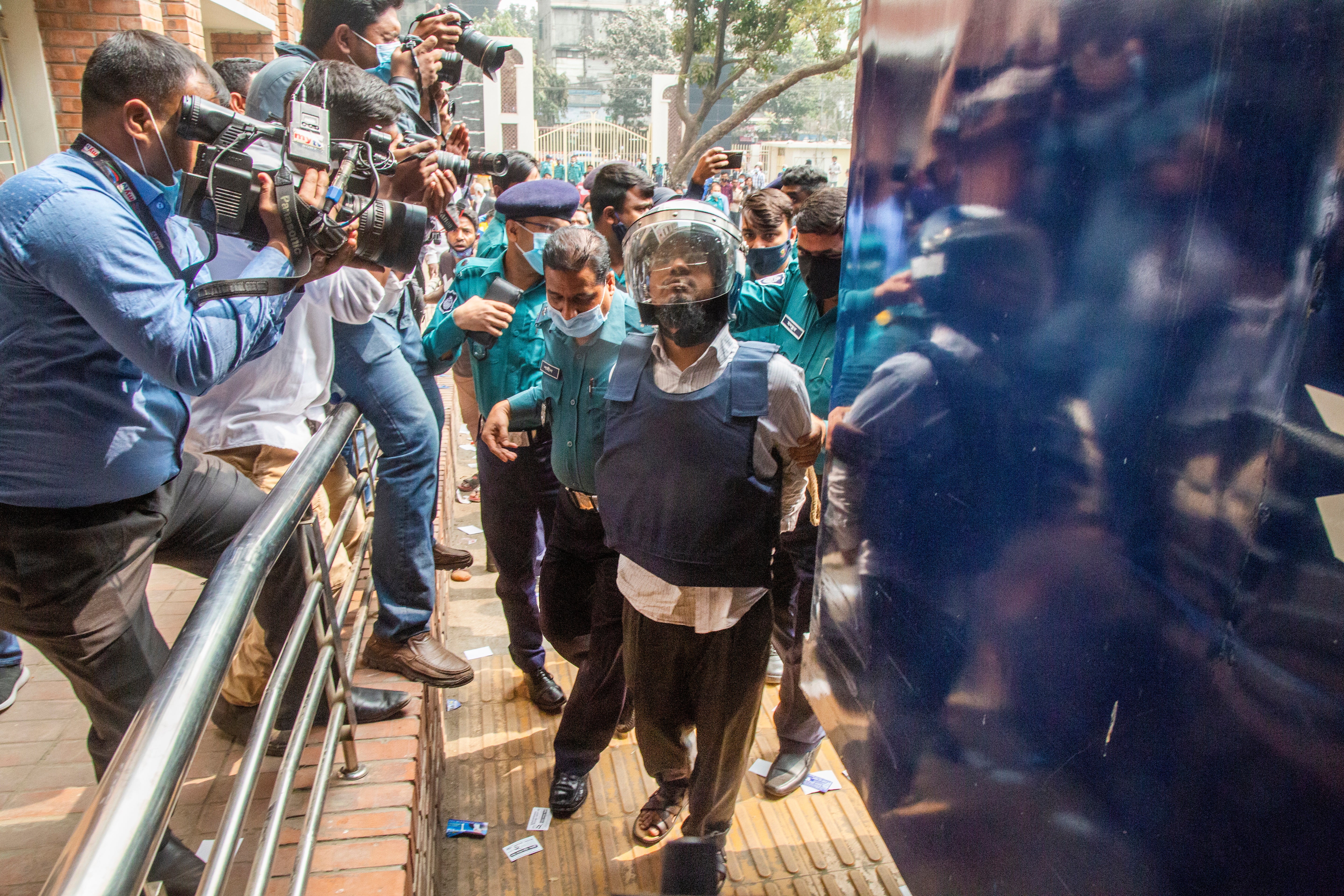 <p>One of the accused murderers of blogger-writer Avijit Roy is escorted to court in Dhaka, Bangladesh in 2021 </p>