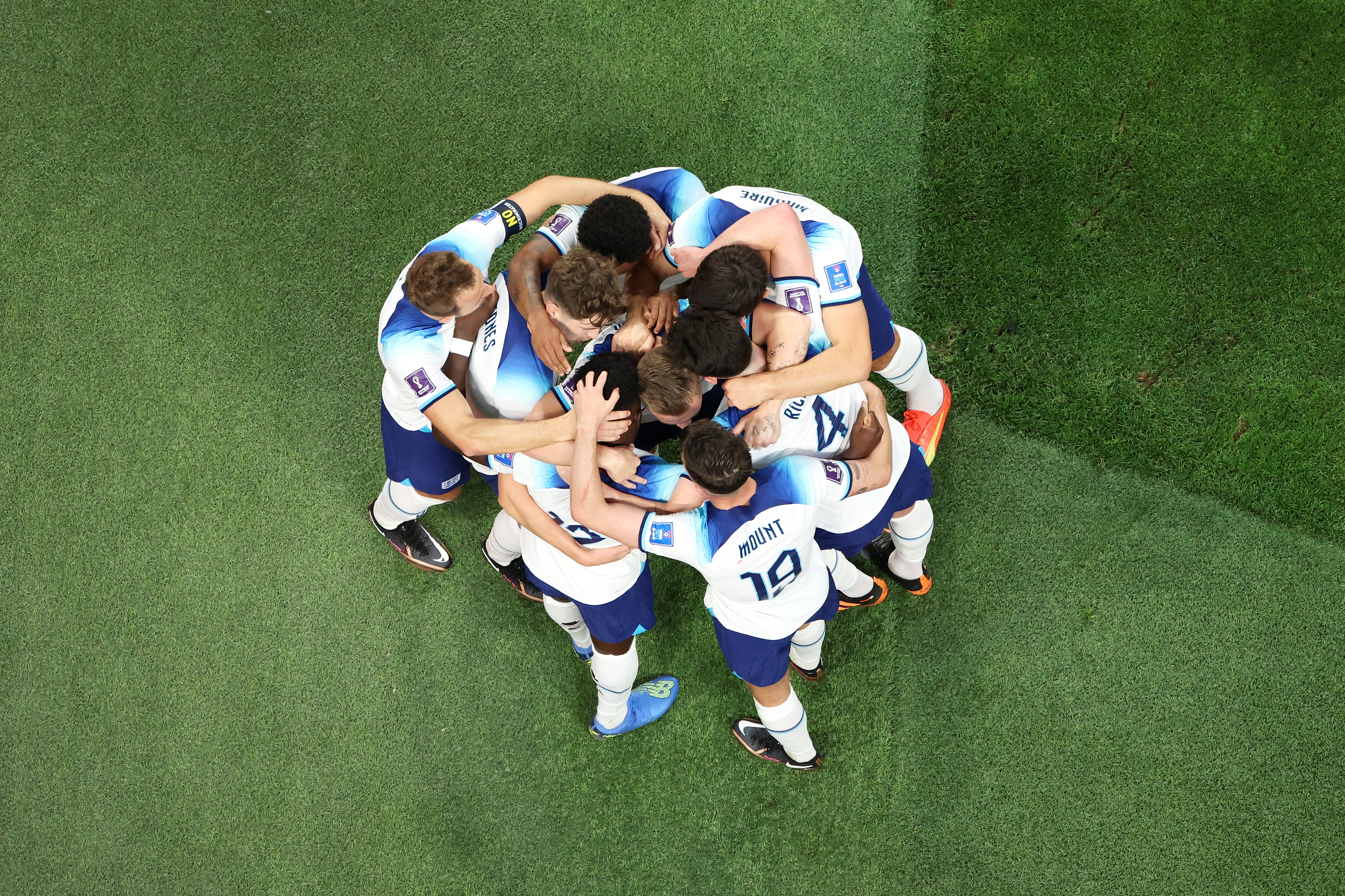 England players huddle after scoring their second