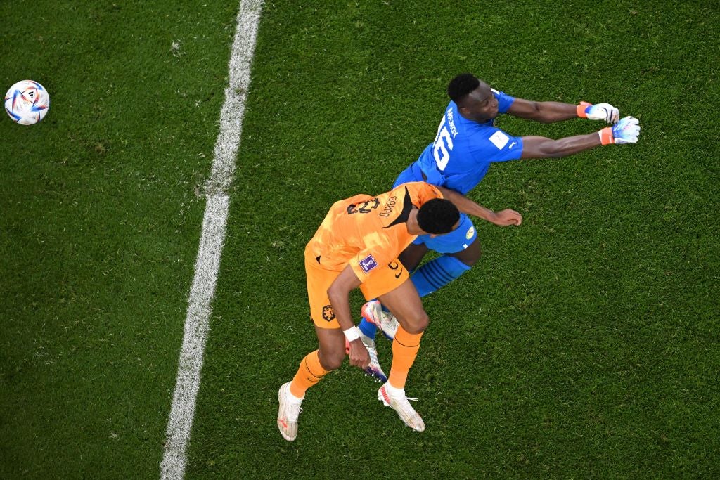 Senegal goalkeeper Mendy is caught by Gakpo’s header