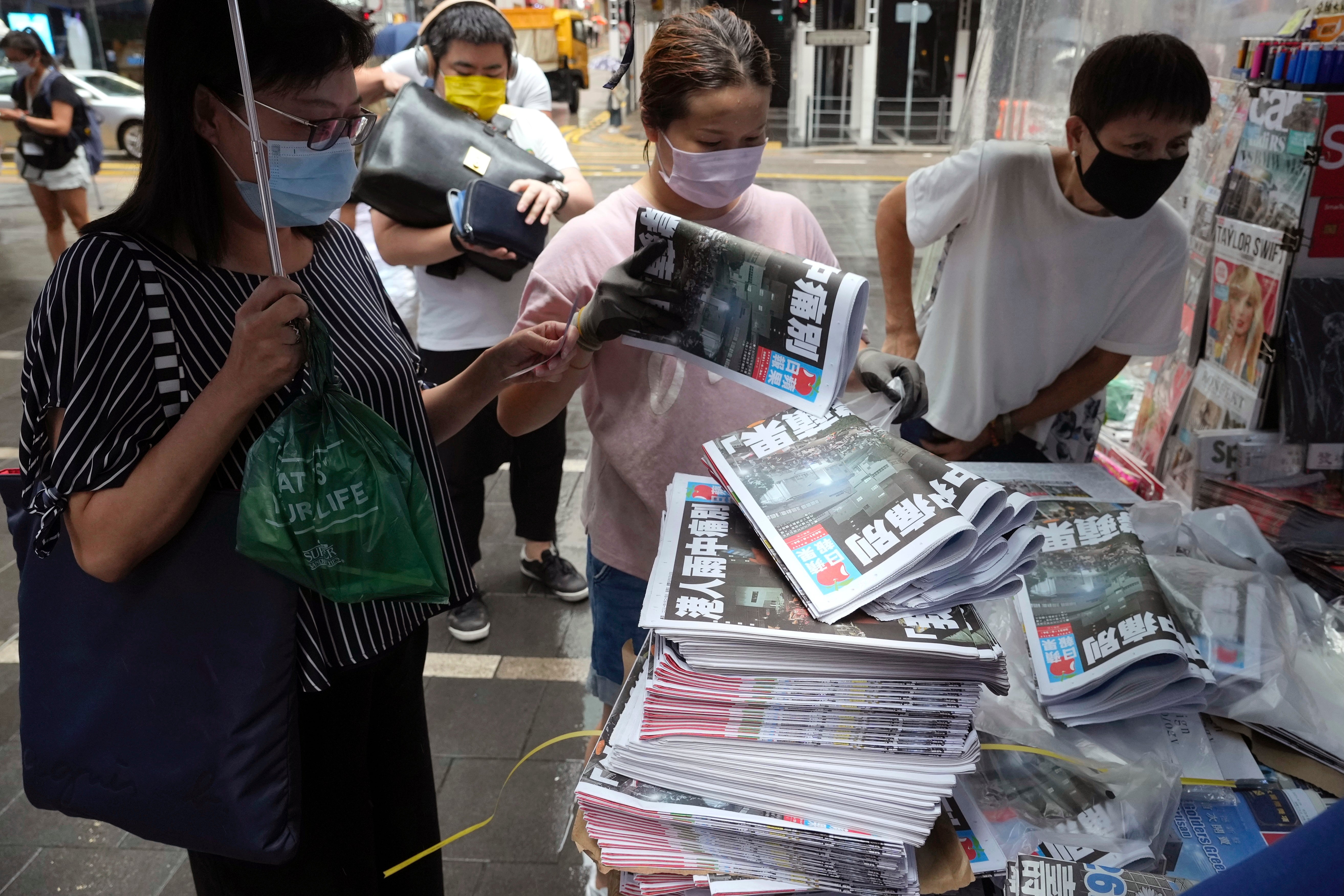People queue up to buy last issue of Apple Daily at a newspaper booth at a downtown street in Hong Kong on 24 June 2021. Six former executives of Apple Daily pleaded guilty to a collusion charge