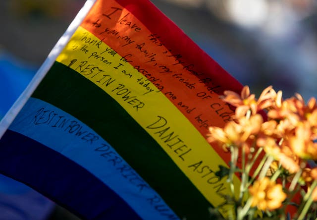 <p>A flag with a message to  victims of the mass shooting at Club Q sits at a memorial outside in Colorado Springs </p>