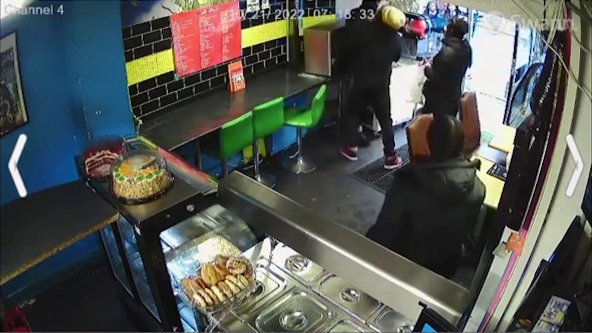 Moment hero restaurant owner wrestles with knifeman in shop