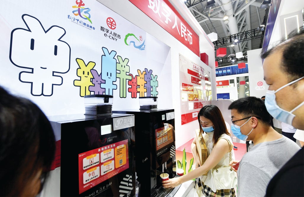 Visitors pay for their coffee using e-CNY during an expo in Fuzhou, Fujian province