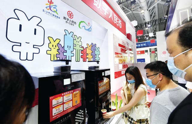 <p>Visitors pay for their coffee using e-CNY during an expo in Fuzhou, Fujian province</p>