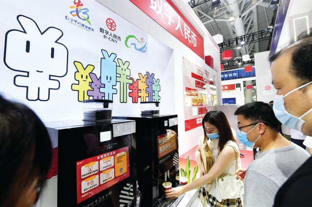 <p>Visitors pay for their coffee using e-CNY during an expo in Fuzhou, Fujian province</p>
