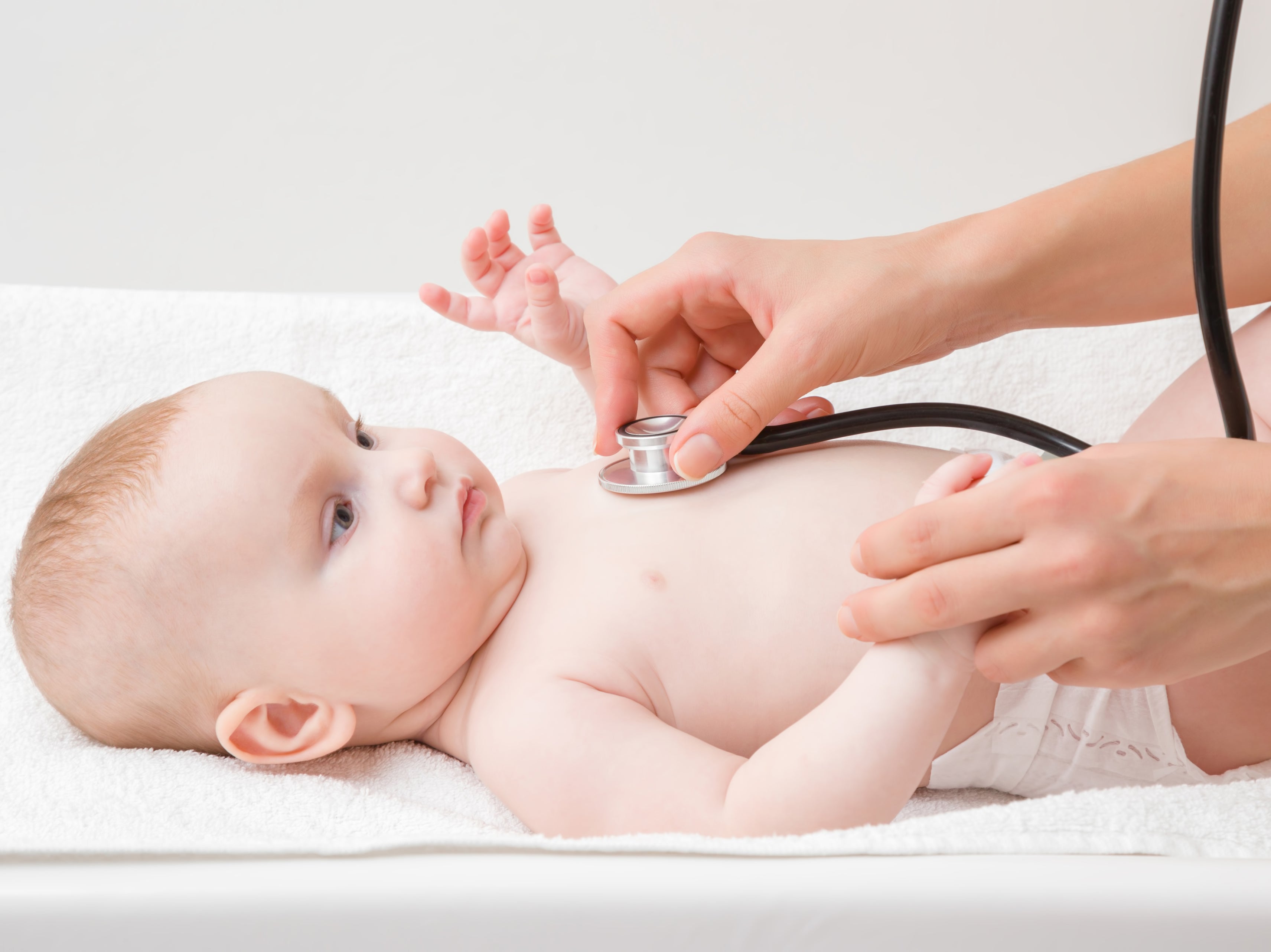 A baby being examined by a paediatrician in hospital