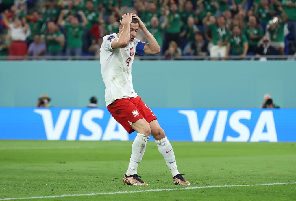 Robert Lewandowski reacts to his penalty miss for Poland against Mexico