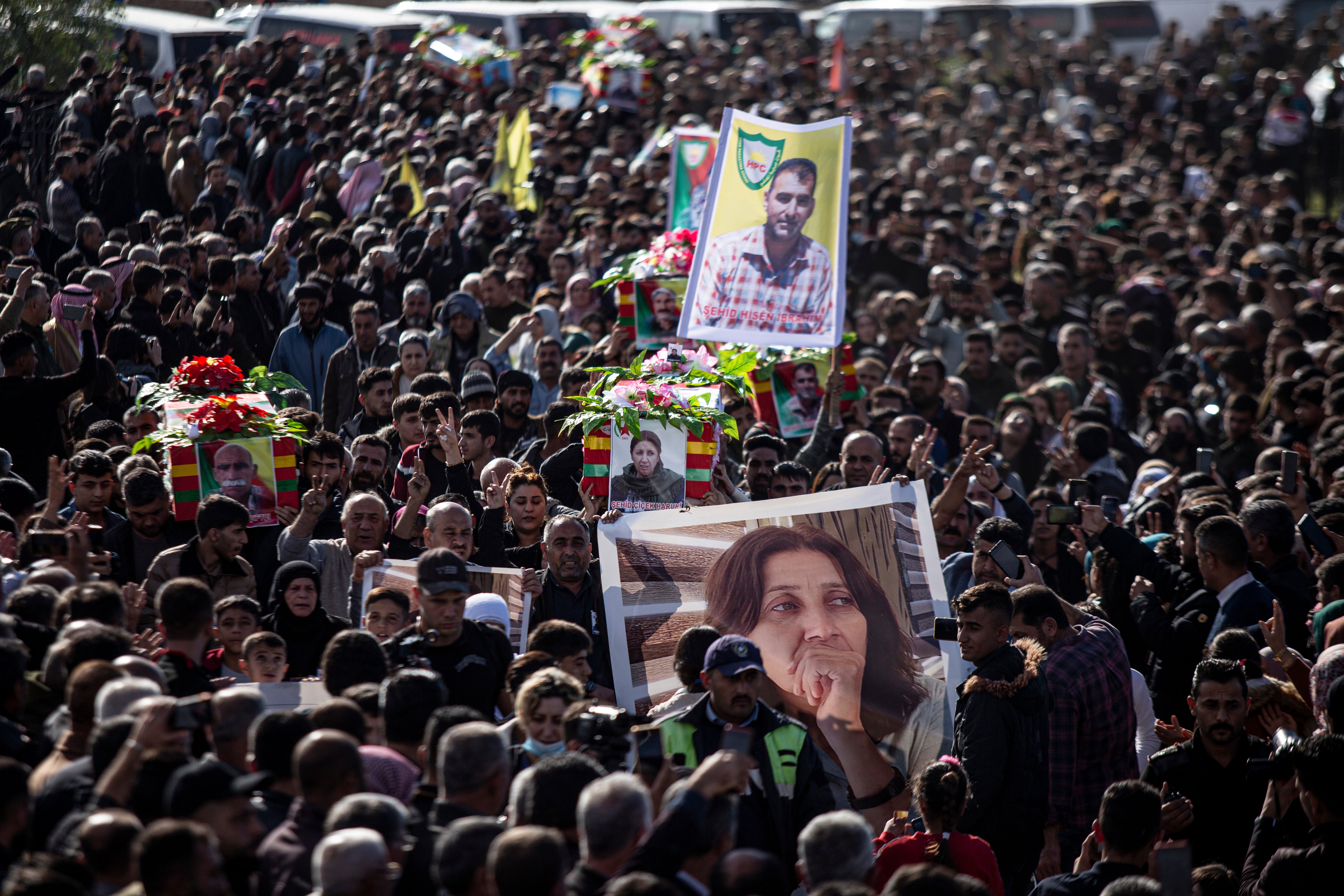 Syrian Kurds attend a funeral of people killed in Turkish airstrikes in the village of al-Malikiyah, northern Syria