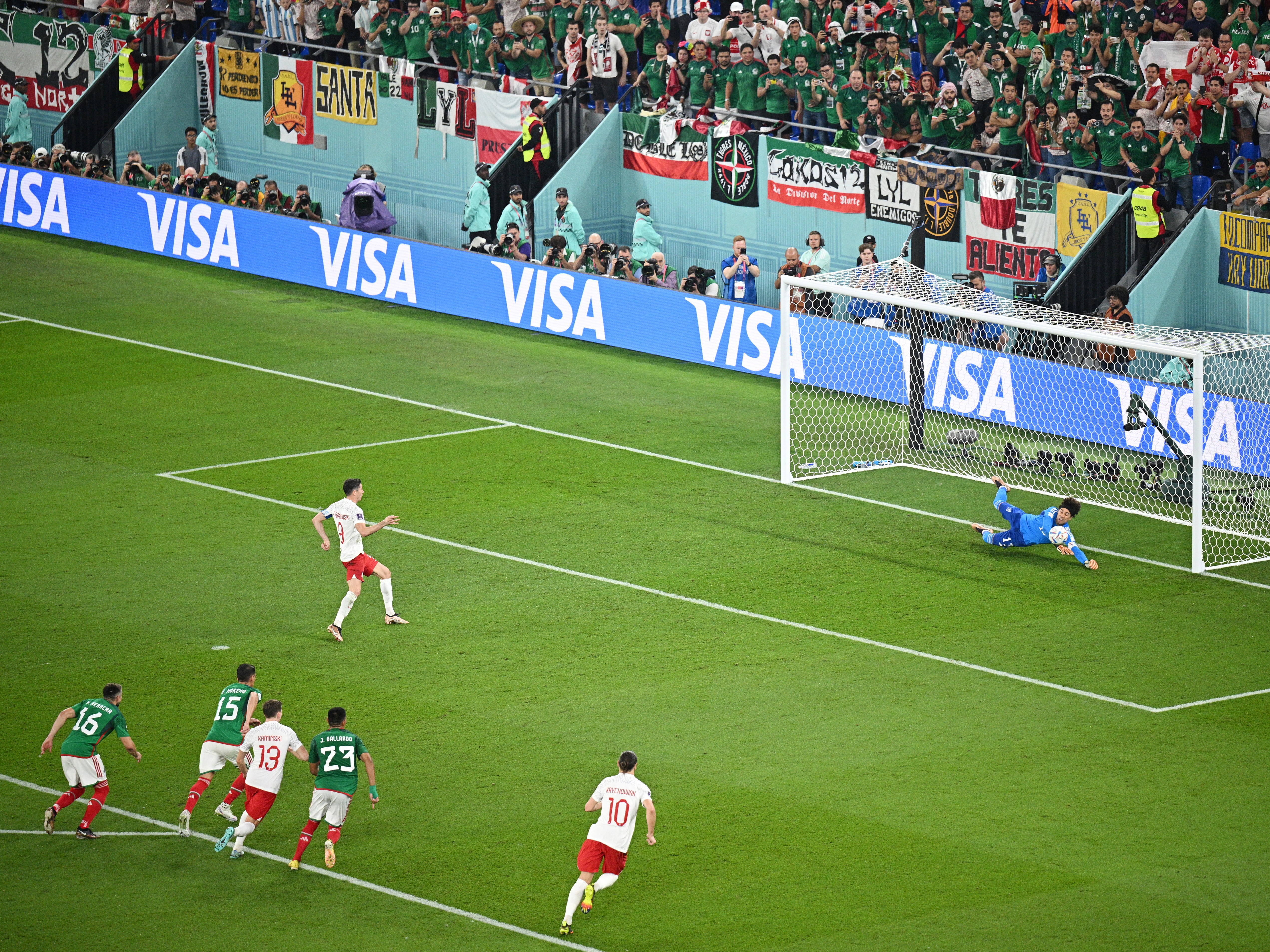 Mexico goalkeeper Guillermo Ochoa saves Robert Lewandowski’s penalty