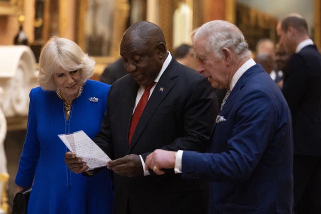 The Queen Consort, President Cyril Ramaphosa of South Africa and the King view a display of South African items from the Royal Collection (Dan Kitwood/PA)