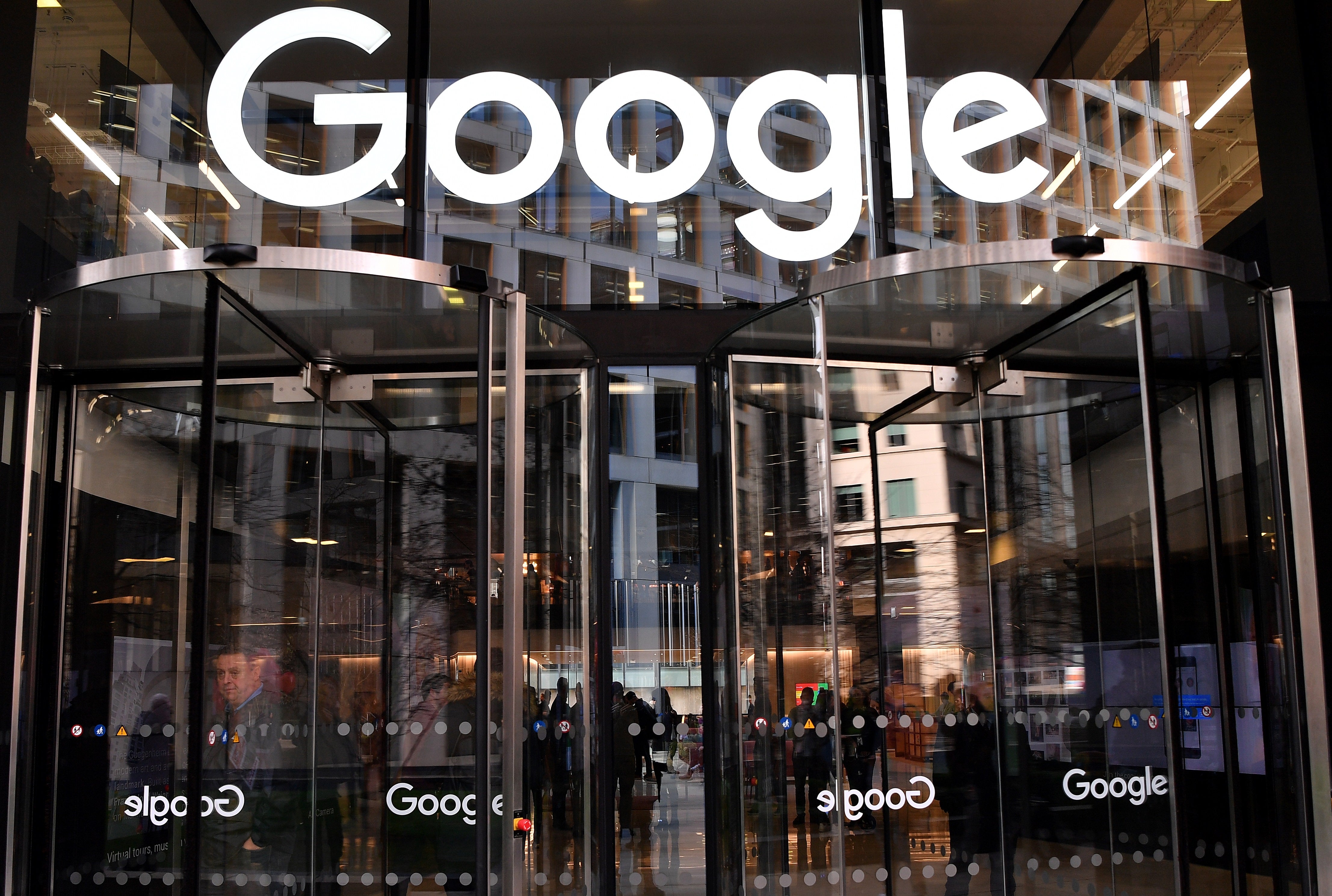 <p>A logo is pictured above the entrance to the offices of Google in London</p>