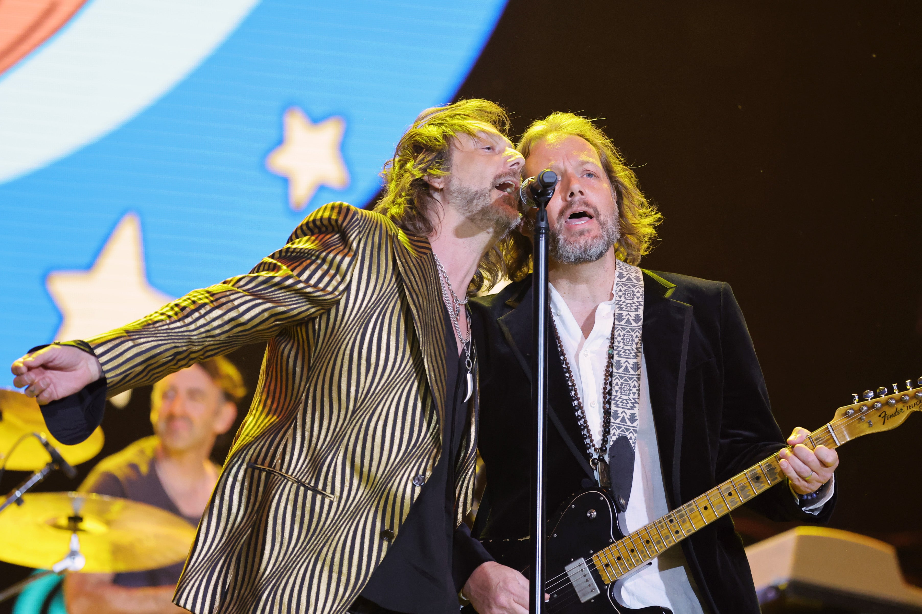 Brothers Chris (left) and Rich Robinson on stage in May