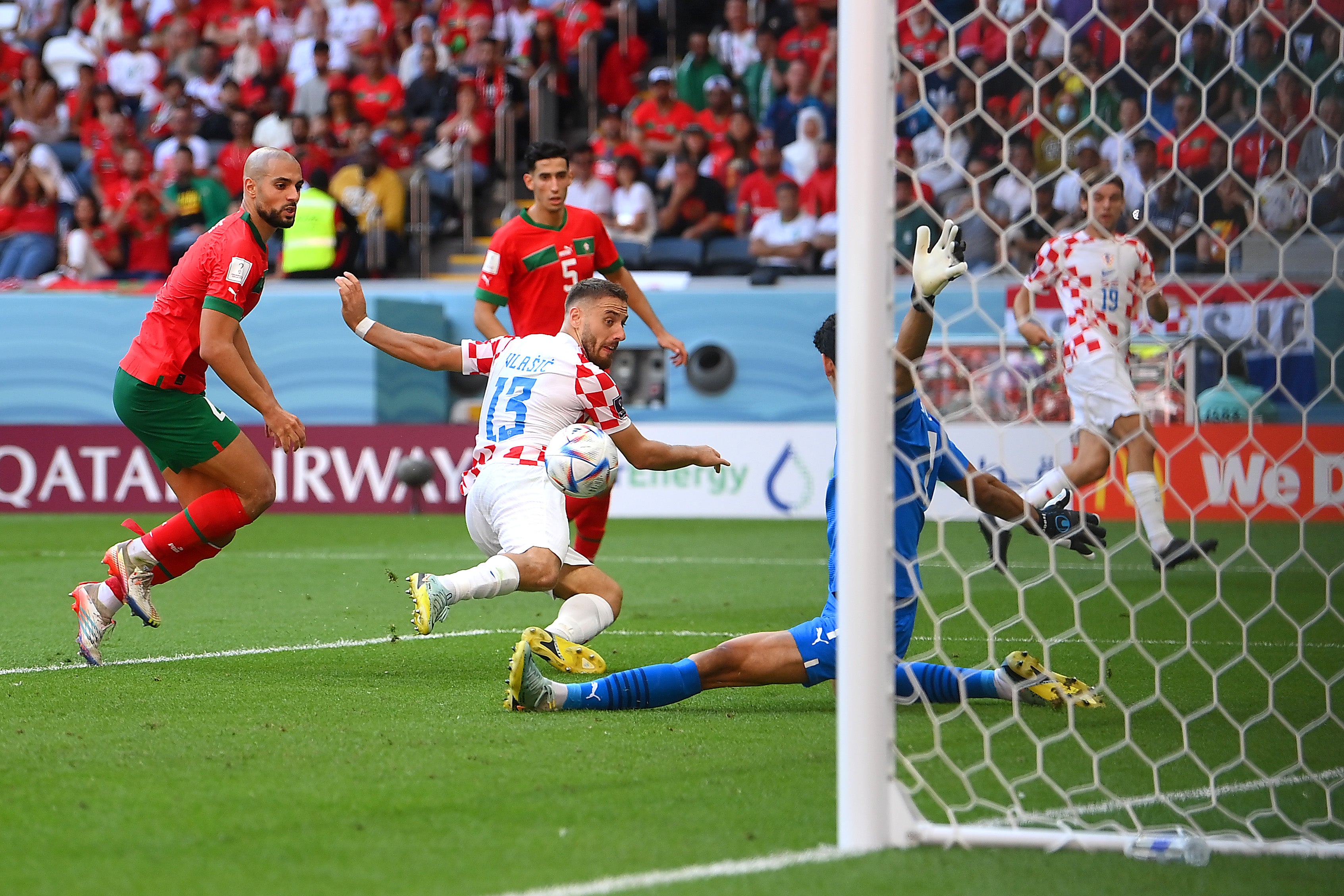 Yassine Bounou of Morocco saves a shot by Nikola Vlasic of Croatia