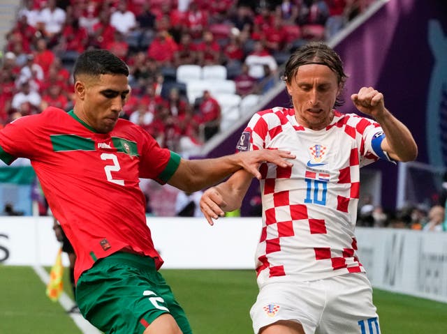<p>Croatia's Luka Modric and Morocco's Achraf Hakimi, left, compete for the ball</p>