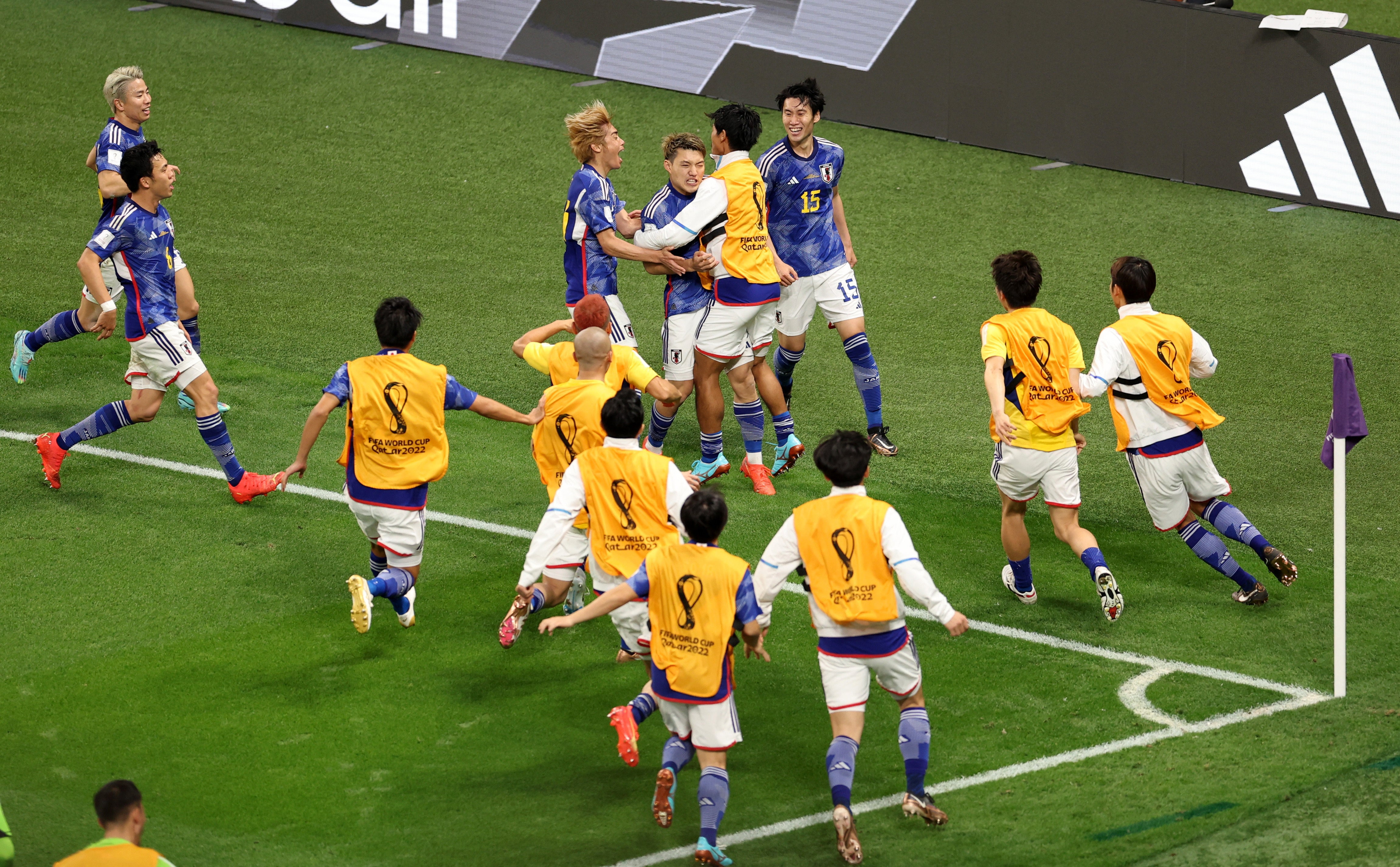 Japan players celebrate after Ritsu Doan scores