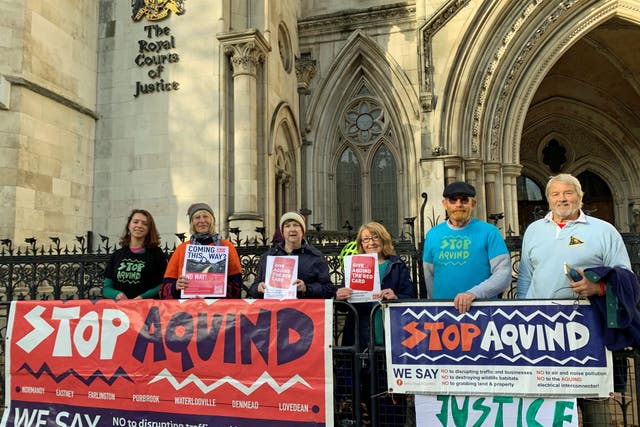 Portsmouth residents and members of the community campaign group Let’s Stop Aquind, outside the Royal Courts of Justice in London (Tom Pilgrim/PA)
