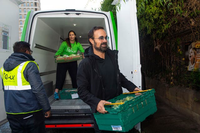 <p>Lord Lebedev distributes food at St Paul’s Primary School in Whitechapel </p>