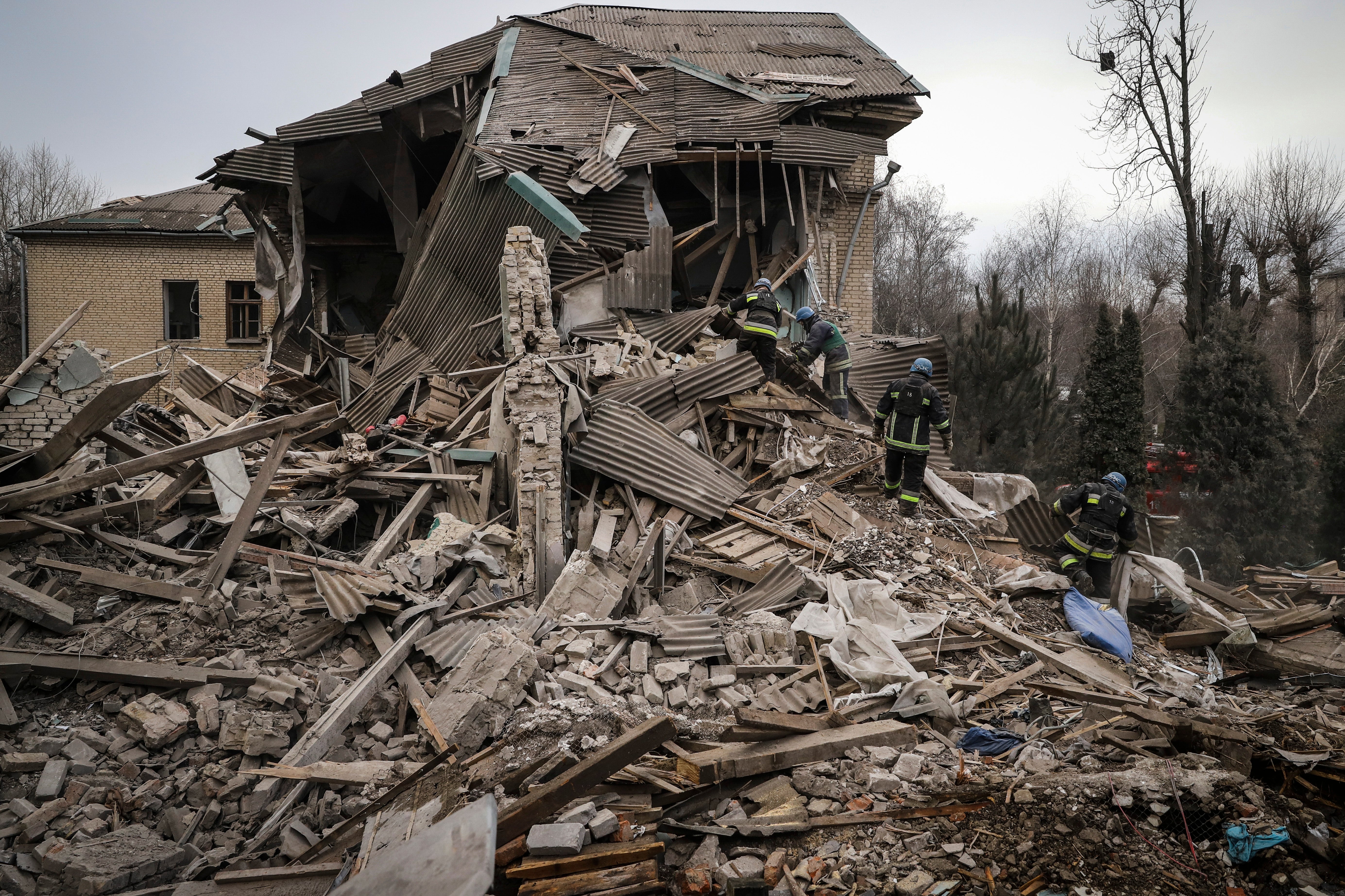 Ukrainian firefighters work at a damaged hospital maternity ward in Vilniansk, Zaporizhzhia region