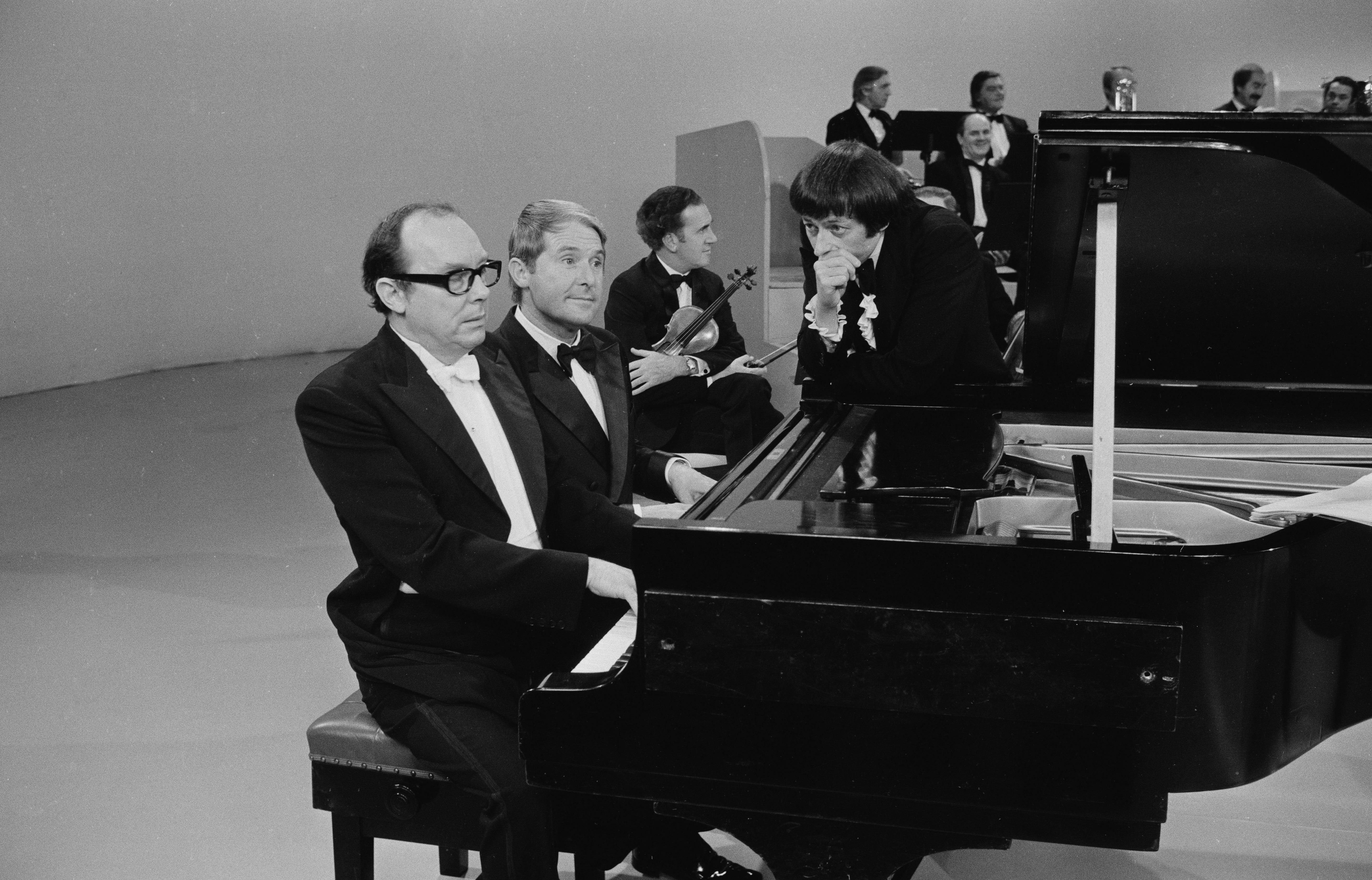 Comedians Eric Morecambe, left, and Ernie Wise, second from left, in a 1971 sketch with pianist Andre Previn, standing