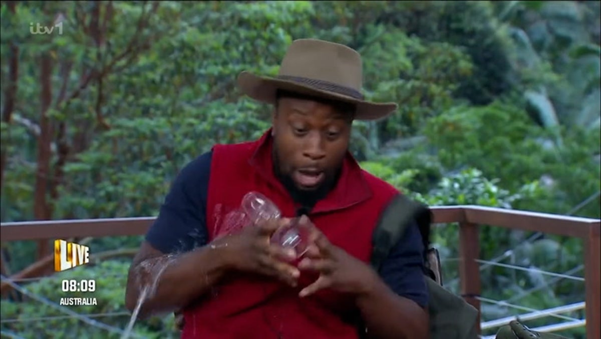 Babatunde Aleshe excitedly spills champagne over himself as he leaves I’m a Celeb
