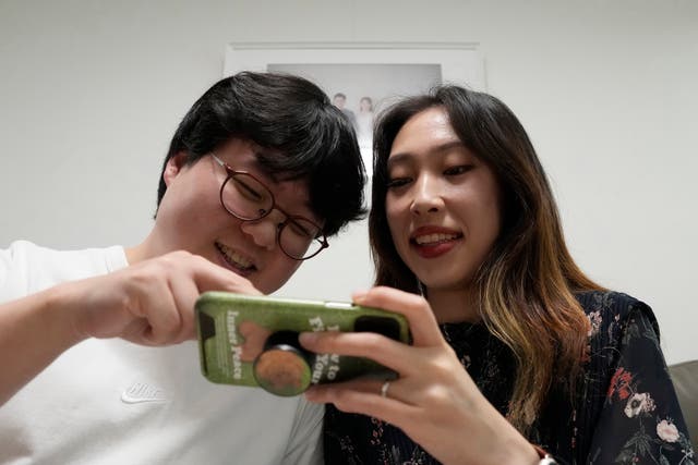 <p>Representative. Yoo Young-yi and her husband Jo Jun-hwi watch their YouTube channel at their home in Seoul, South Korea, Sunday, 2 October 2022. - Many young people in South Korea have chosen not to marry or have children, citing a change of views toward a marriage and family life and uncertainty of their future</p>
