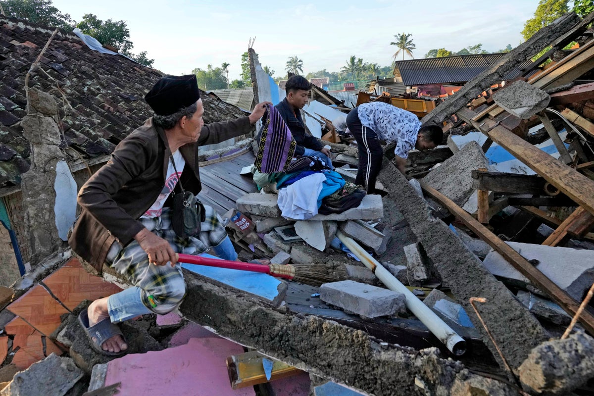 Indonesian boy, 6, buried under debris for two days after earthquake pulled out alive