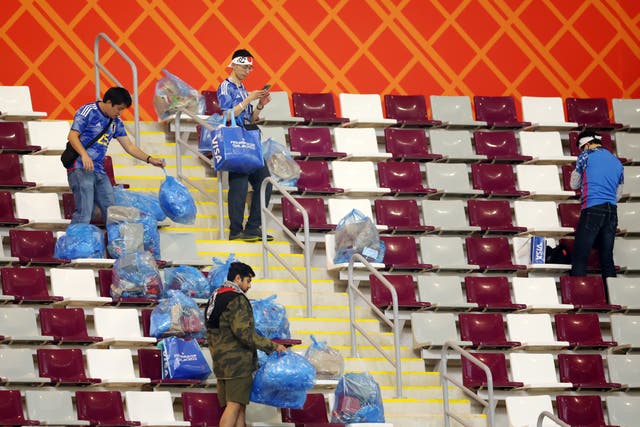 <p>Japanese football fans have been caught on camera cleaning up their part of the stadium </p>