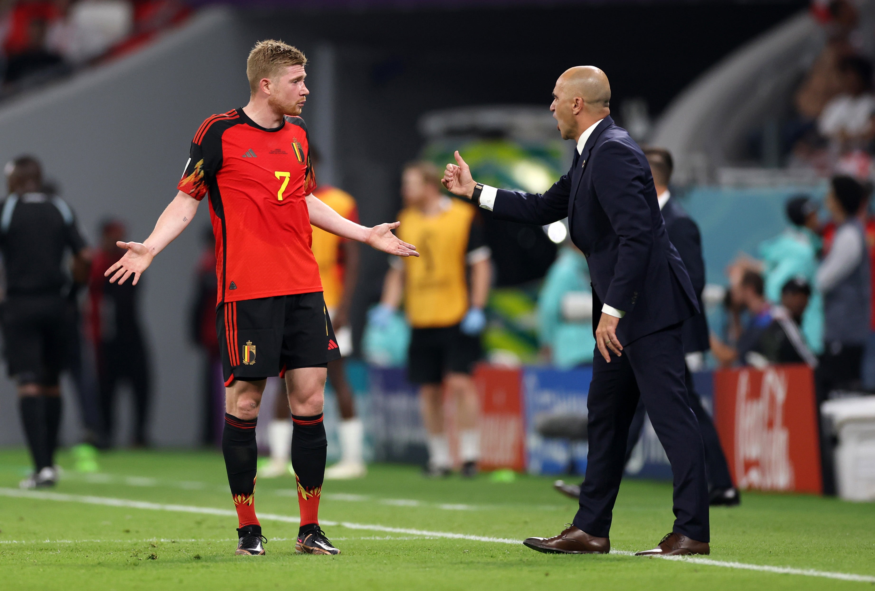 <p>Kevin De Bruyne in discussion with manager Roberto Martinez</p>