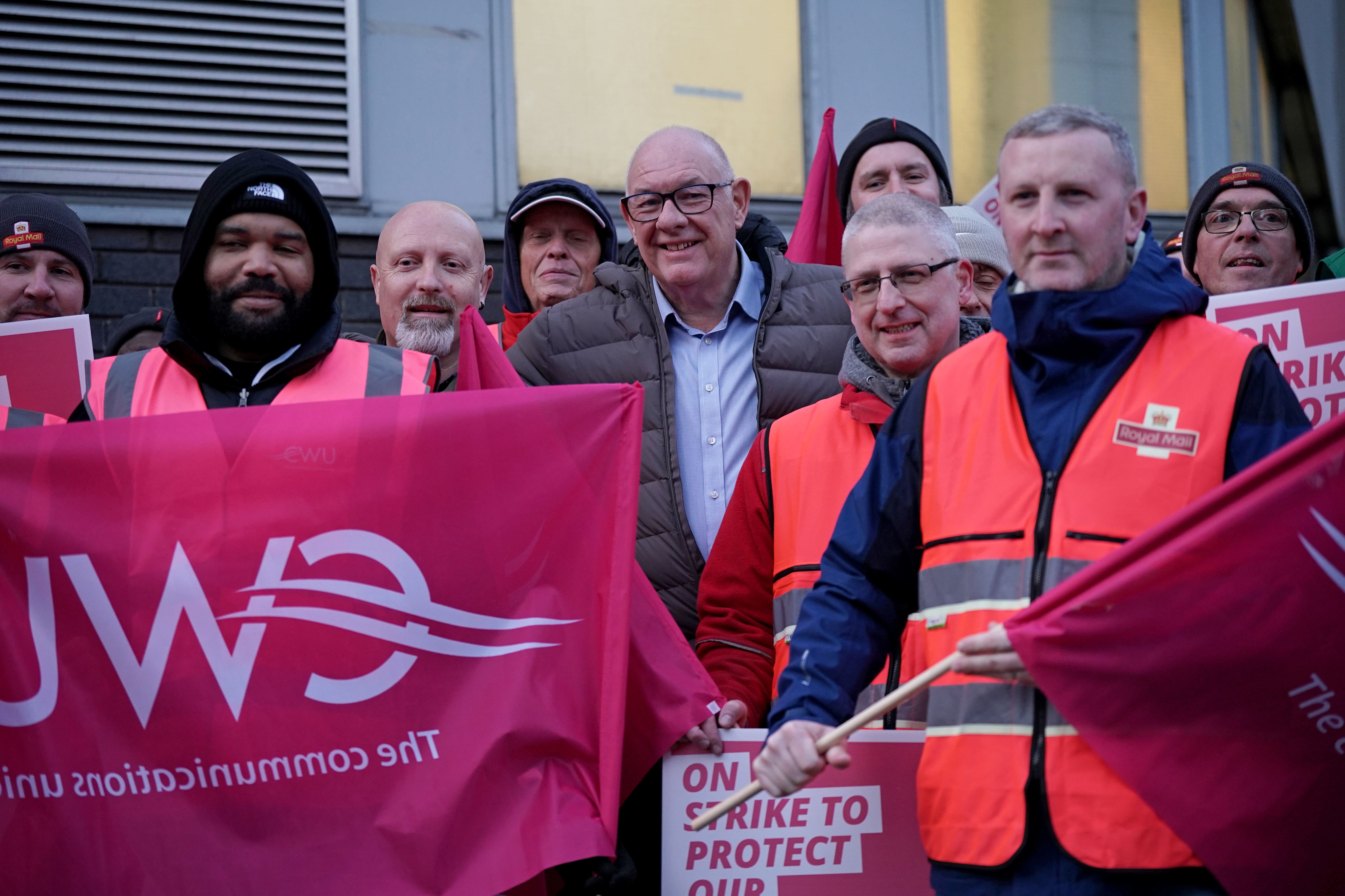 Communication Workers Union general secretary Dave Ward (centre) joins postal workers on the picket line in Camden, north London (Yui Mok/PA)