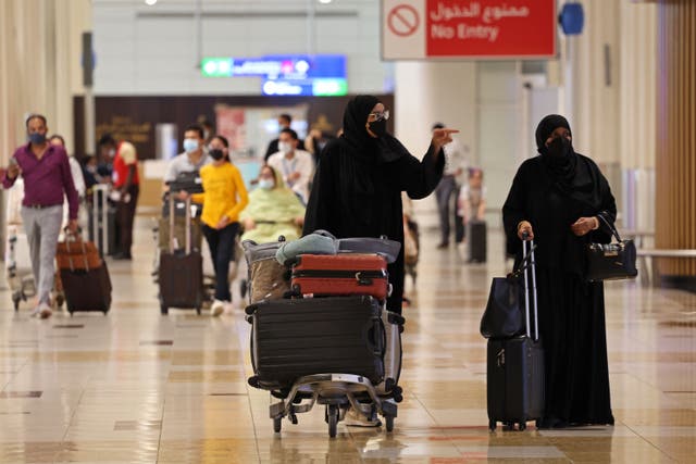 <p>Travellers walk at Dubai Airport Terminal 3 in the Gulf emirate of Dubai, on 16 August 2022</p>