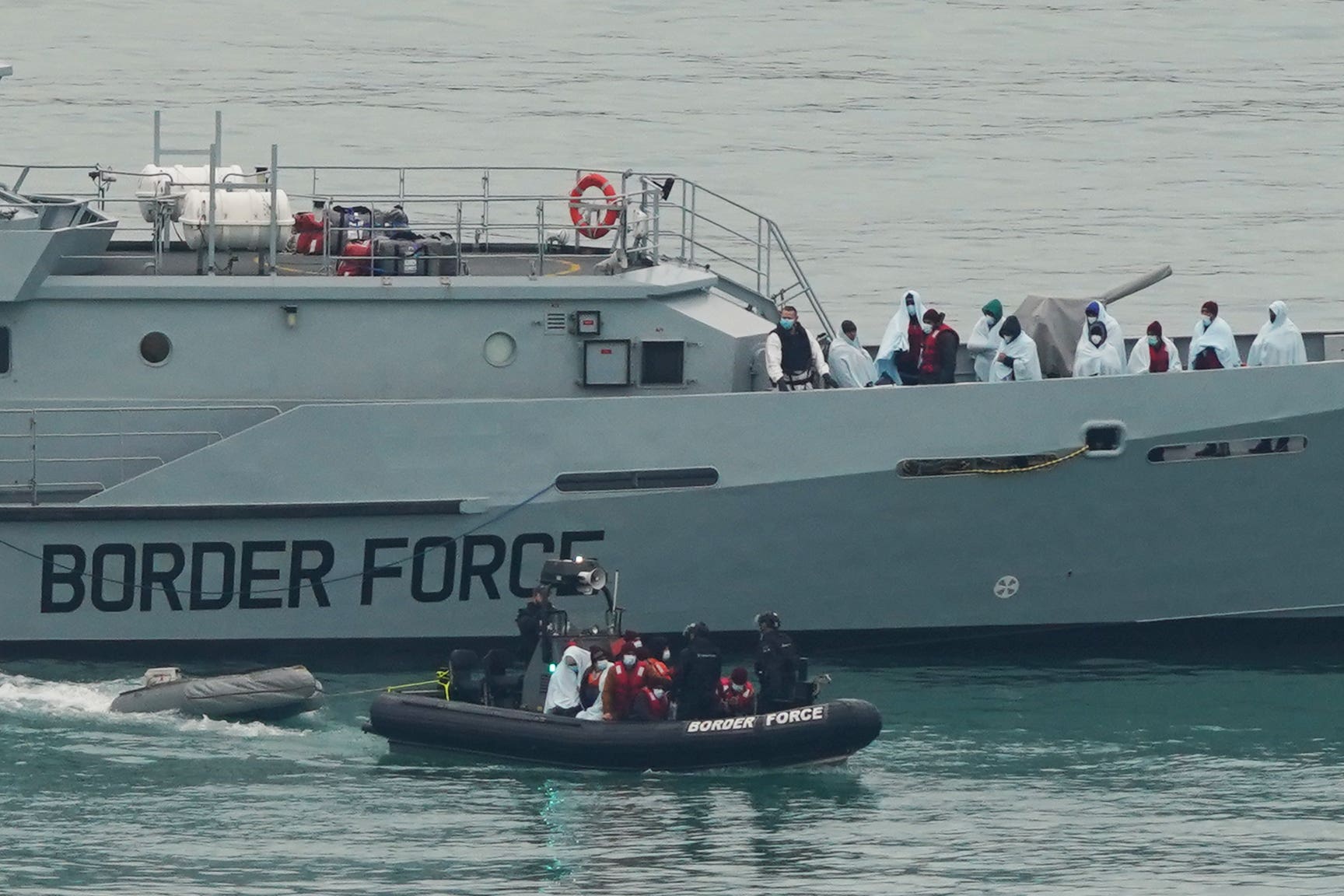 A group of people thought to be migrants being brought in to Dover, Kent, by Border Force officers, following a small boat incident in the Channel. Picture date: Thursday December 16, 2021 (Gareth Fuller/PA)
