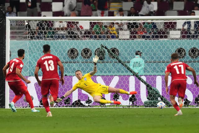 Iran’s Mehdi Taremi beats England goalkeeper Jordan Pickford from the penalty spot (Martin Rickett/PA)
