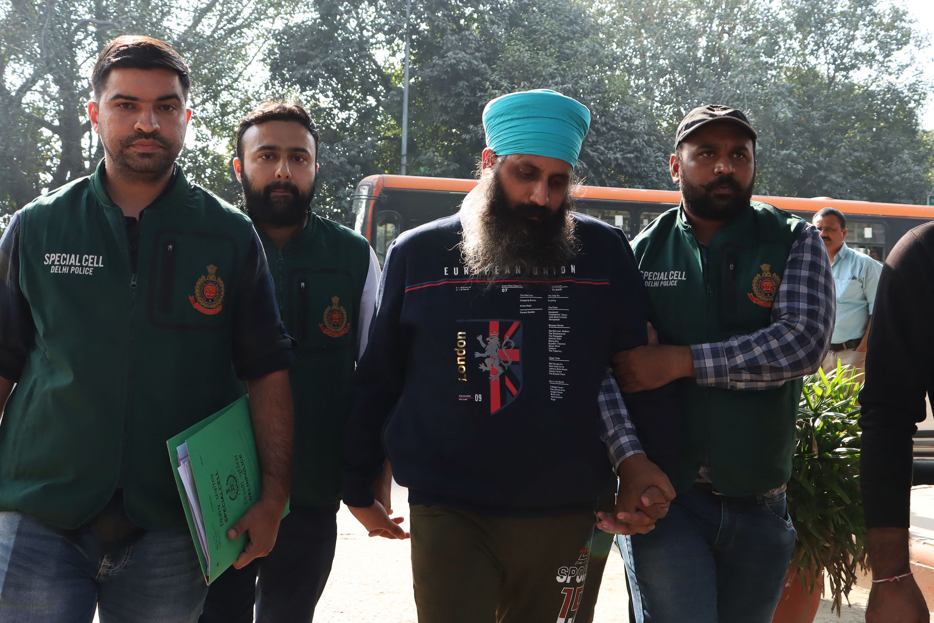 Delhi Police Special Cell officers escort Rajwinder Singh (2L) to Patiala court after being arrested in relation to the 2018 murder of Australian national Toyah Cordingley