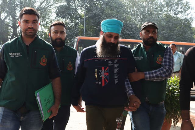 <p>Delhi Police Special Cell officers escort Rajwinder Singh (2L) to Patiala court after being arrested in relation to the 2018 murder of Australian national Toyah Cordingley</p>