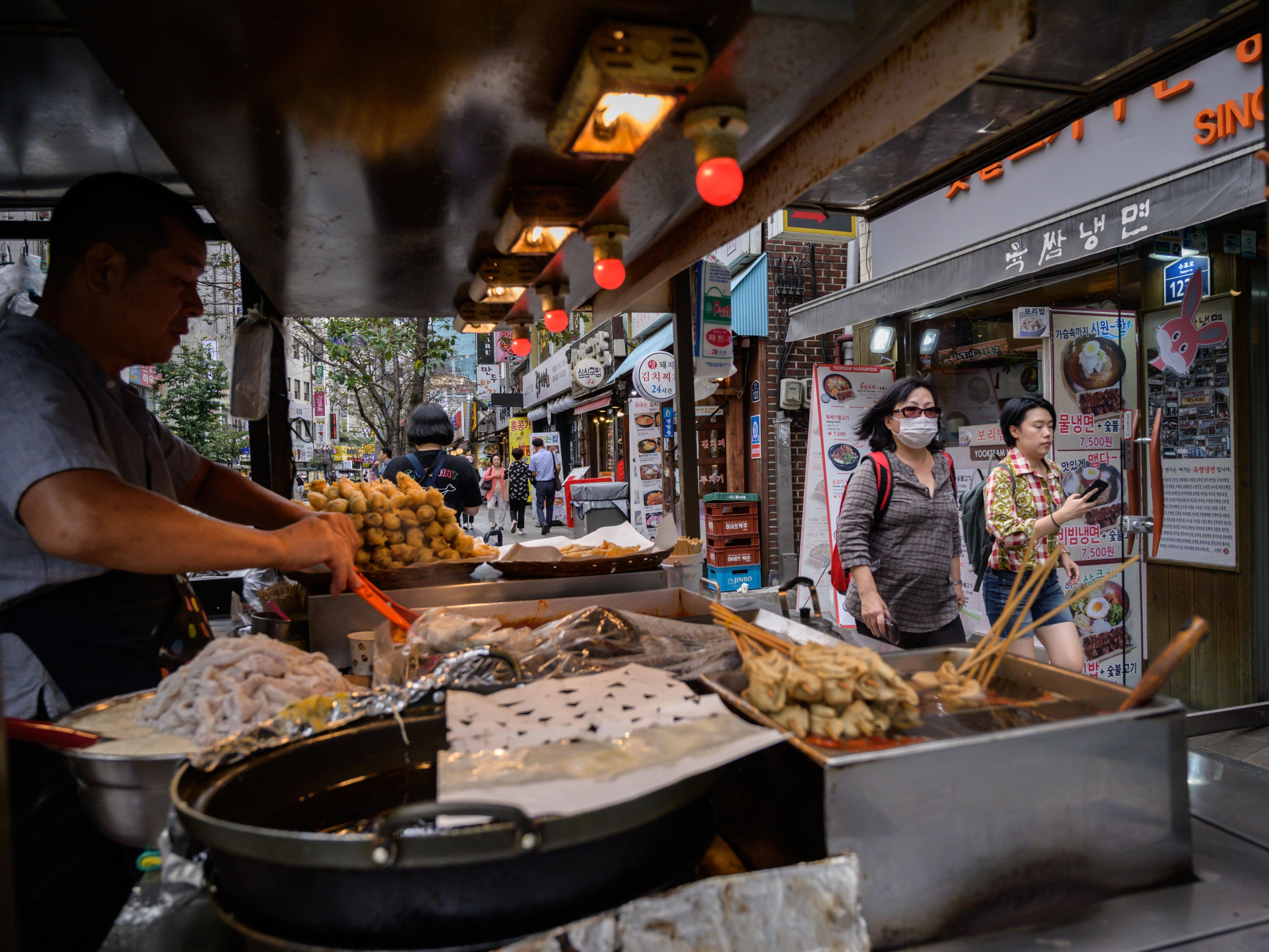 Representational image: A snack vendor prepares food at a stall on a street in Seoul