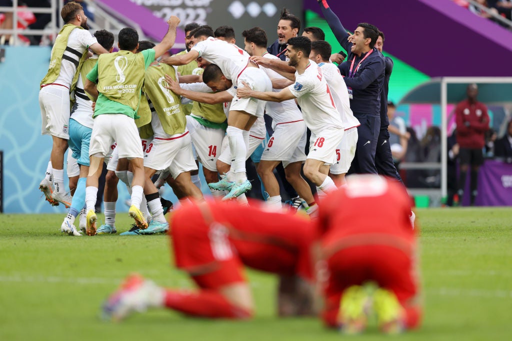 Iran’s Roozbeh Cheshmi celebrates with teammates after scoring the goal that broke the deadlock – and Welsh hearts – in added time